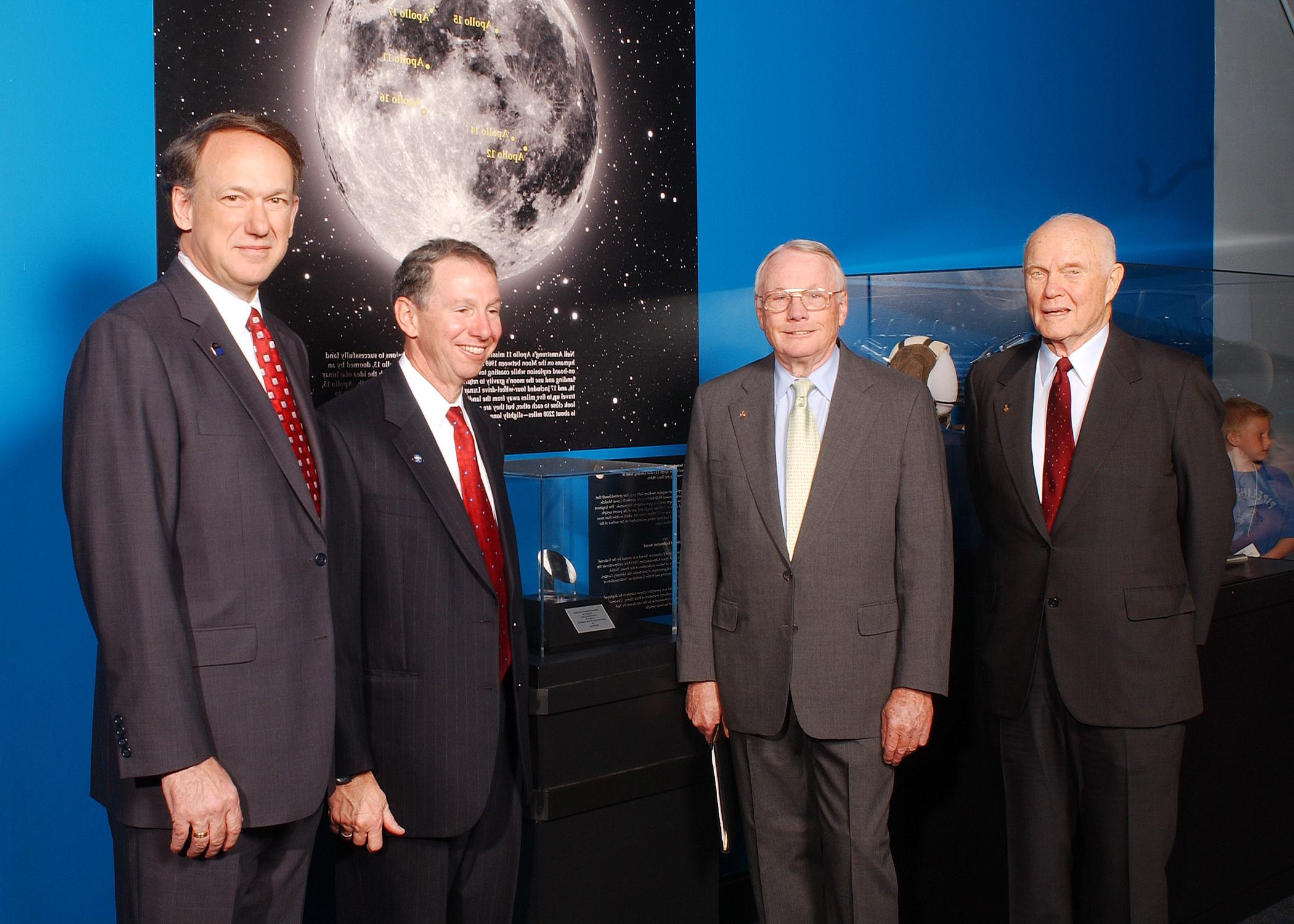 astronauts in front of space rock